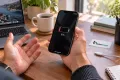 iPhone 11 Pro ile düşük şarj seviyesini fark eden müşteri; Teknonand logolu masa